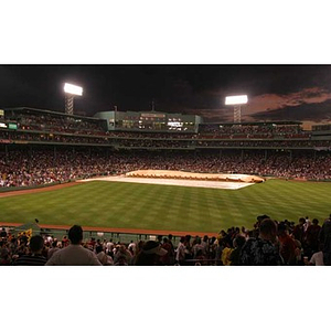 The tarp is taken off the field at Fenway Park when the Torch Scholars visit