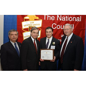 New inductee James Bonetti poses with his certificate and others at The National Council Dinner