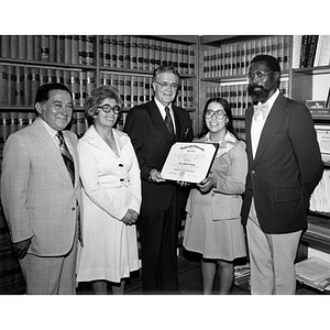 Four people pose with Dean John O'Byrne at the 1976 Law School commencement reception