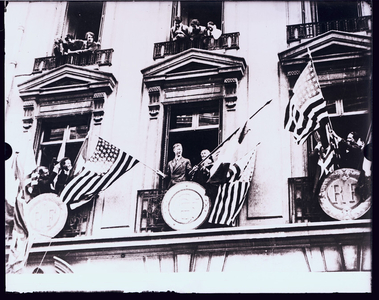 Charles Lindbergh watching the parade, with others, from window balconies, Boston, Mass., 22 July 1927