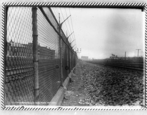 Chain link fence with tracks on the left