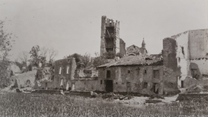 Ground-level view of destroyed stone buildings and clock tower