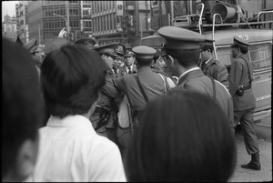 Antiwar demonstrator being arrested, downtown Tokyo