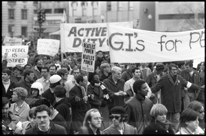 Anti-war protesters marching at the Counter-inaugural demonstrations, 1969, with banners and signs: 'GI's for Peace,' 'Beatle Power,' 'Active duty GIs,' and 'To rebel is justified'