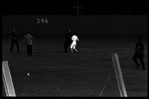 Beatles concert at Shea Stadium: police grabbing a Beatles fan running onto the outfield grass