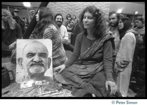 Cathy Brown (Usha) with a portrait of Neem Karoli Baba during an appearance by Ram Dass at the College of Marin