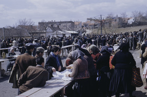 Men watching clothing trade at Belgrade market