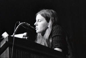 Bernadette Devlin McAliskey at the podium during a talk at Northeastern University