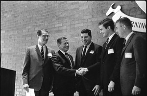 Governor Volpe and Elliot Richardson at Boston University: Richardson on stage with Volpe, who greets three other men