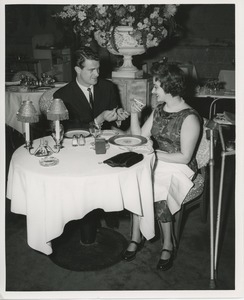 Man lighting cigarette for June Trietsch Arzt at a restaurant