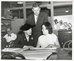 Mary Switzer speaks with a woman at work at the Institute for the Crippled and Disabled