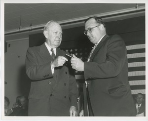 Jeremiah Milbank, Sr. handing a gift to an unidentified man at Institute Day