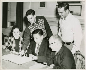 Group of people looking an open Notebook