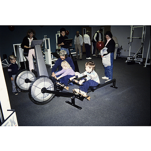 Children and adults using exercise machines