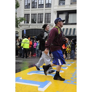 A couple of "One Run" participants touch the Copley Square finish line