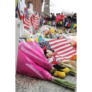 American flag and Mickey Mouse doll at Boston Marathon memorial