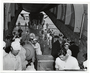 Unidentified men unload medical equipment from an aircraft