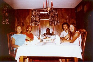 A Photograph of Marlow Monique Dickson Sitting with Others at a Dinner Table