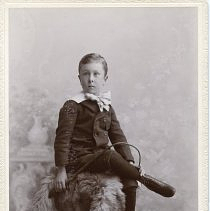 Young Boy on Fur Covered Pedestal