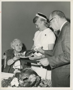 Dr. DiMichael serving Thanksgiving dinner