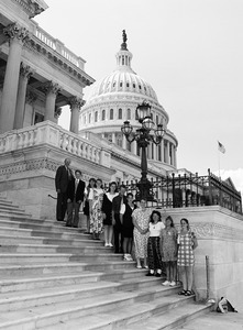 Congressman John W. Olver (left) with group of visitors, posed on the steps of the United States Capitol building
