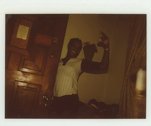 A Photograph of Marsha P. Johnson Holding Cash Near a Door