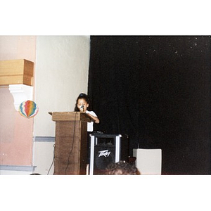 Girl at the podium at the Jorge Hernandez Cultural Center during a Teen Empowerment Program event.