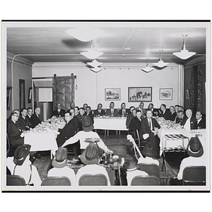"Board members seated at dinner at annual meeting"