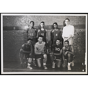 A Boys' Club basketball team posing with their trophy