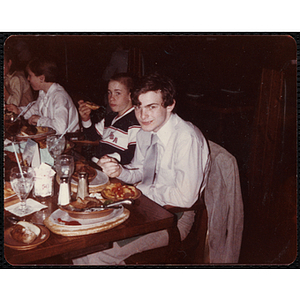 Several teenage boys eating at a table at a Charlestown Boys & Girls Club event