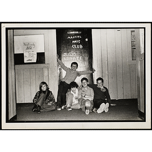 Members of the Martial Arts Club posing outside their dojo