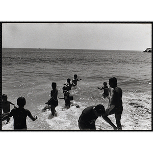 Children swim in the surf at a beach