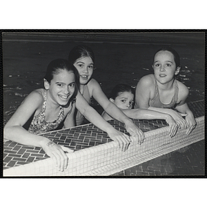 Four girls pose for a shot in a natorium pool