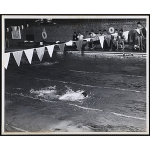 A teenage boy competes in swimming race