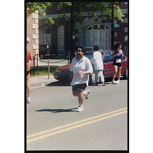 A woman runs in the Battle of Bunker Hill Road Race