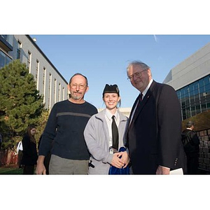 Neal Finnegan poses with a man and a student at the Veterans Memorial dedication ceremony