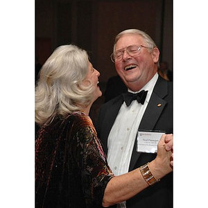 Chairman Emeritus of the Board of Trustees Neal Finnegan, right, dancing with a guest at a dinner honoring members of the Huntington Society
