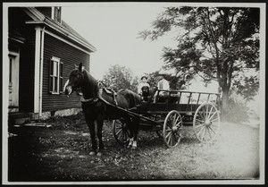 Two children in the driver's area of a wagon, York, Maine undated