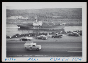 Steamship moving through the Cape Cod Canal with automobiles in the foreground