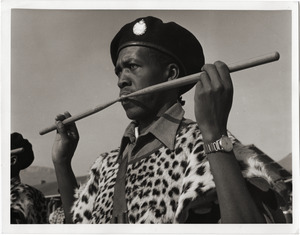 A drummer in the band of Maseru Police Training School: wearing leopard-skin apron