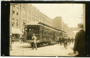 Interurban rail car in front of Remington UMC plant and Union Block, possibly Ilion, N.Y.