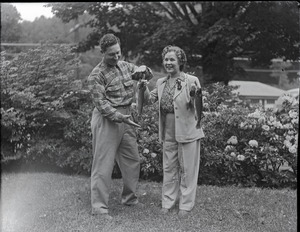 Osa Johnson, holding fish she has caught, with either Charles A. Pope or Fred Brown