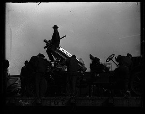 Soldiers operating three-inch anti-aircraft gun mounted on a railcar