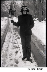 Unidentified woman in the snow with 16mm motion picture camera