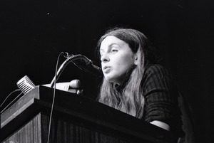 Bernadette Devlin McAliskey at the podium during a talk at Northeastern University