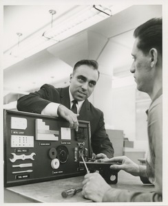 An instructor works with a trainee at TOWER lock assembly evaluation