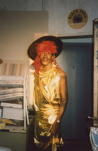 Photographs of Marsha P. Johnson Standing in a Gold Dress, Black Hat, and Red Hair