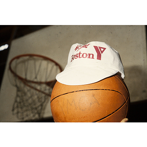 Basketball with a Boston Young Men's Christian Association cap on top of it