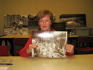 Patricia Willis holding a photograph of her grandfather Patrick Downey at the American Tool Company in Hyde Park, Massachusetts