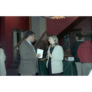 Two people chat in the lobby of the Jorge Hernandez Cultural Center during the Annual Meeting.